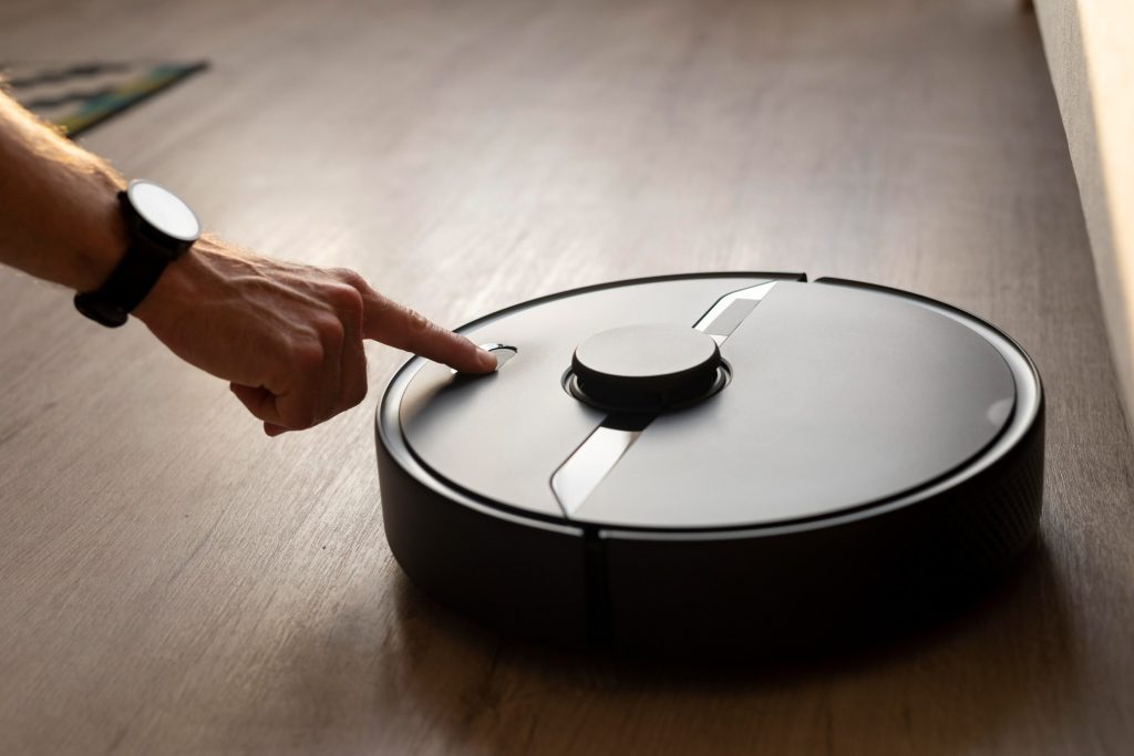 man using robot vacuum living room (1)